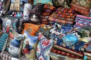 A pile of colorful pillows sitting on top of a table